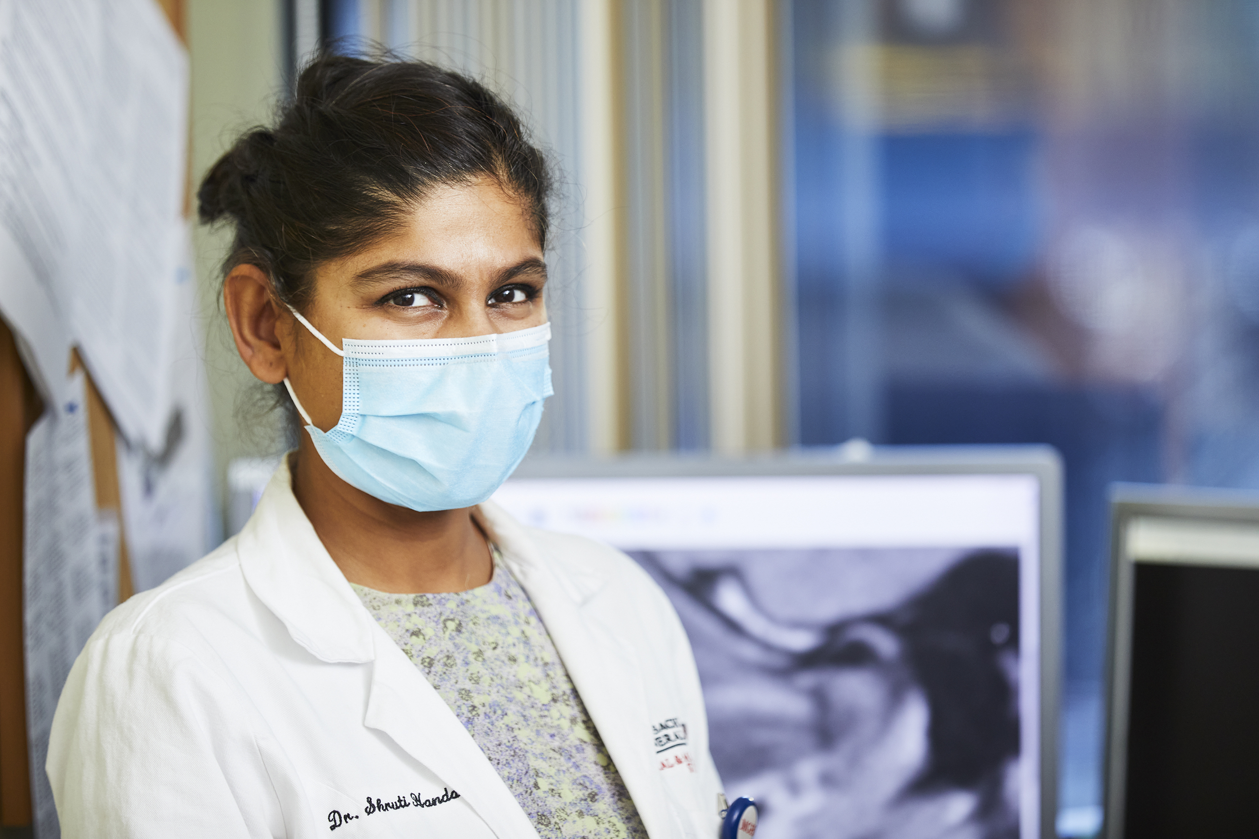 Physician smiling behind a mask